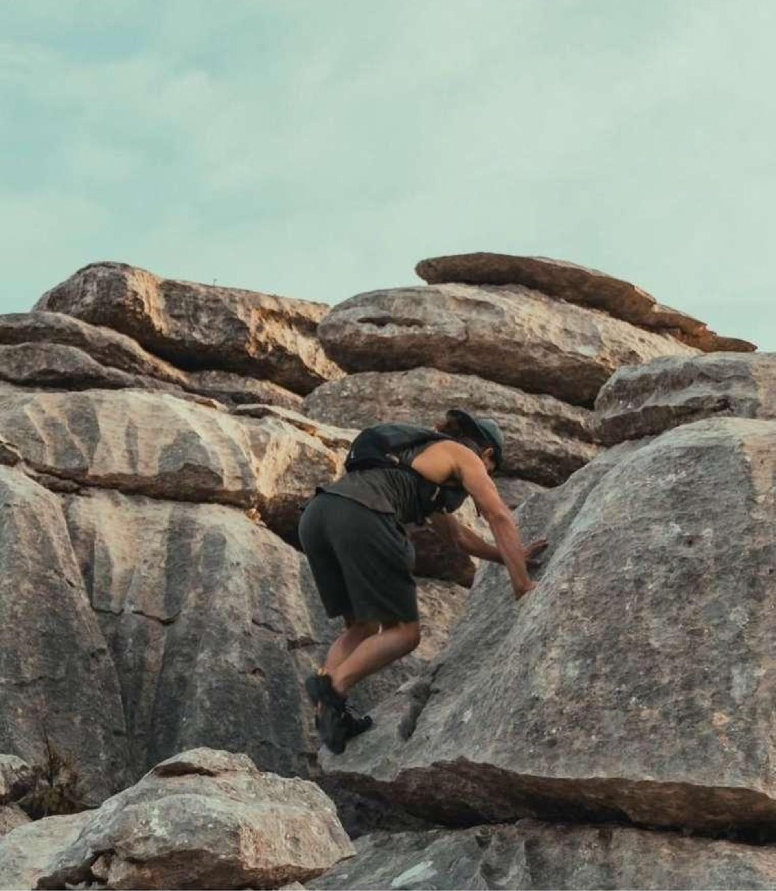 A man scrambling alone up the rock