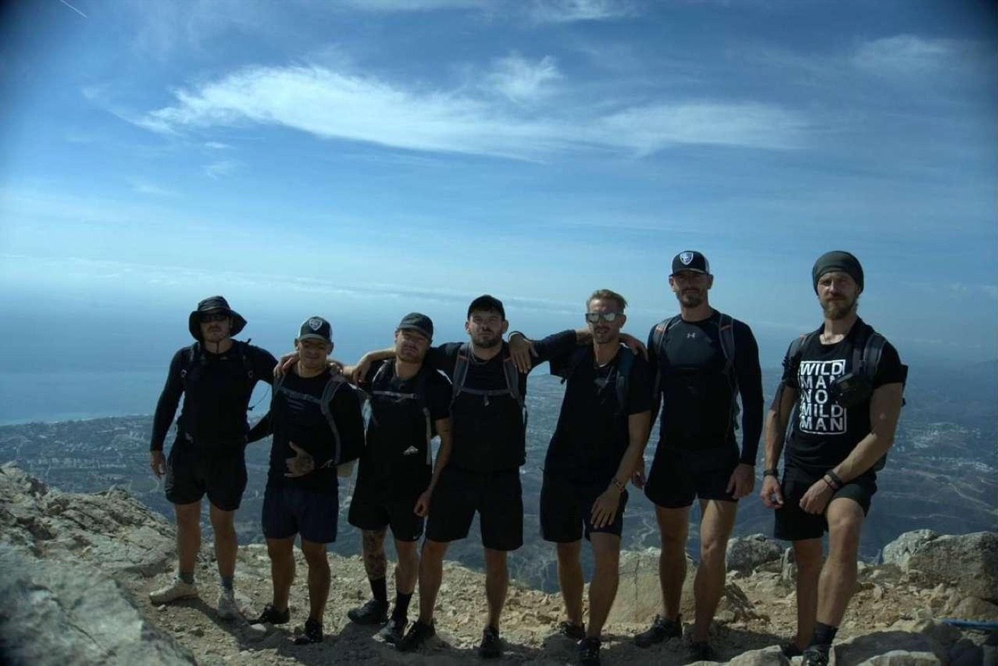 The group arm in arm on the summit