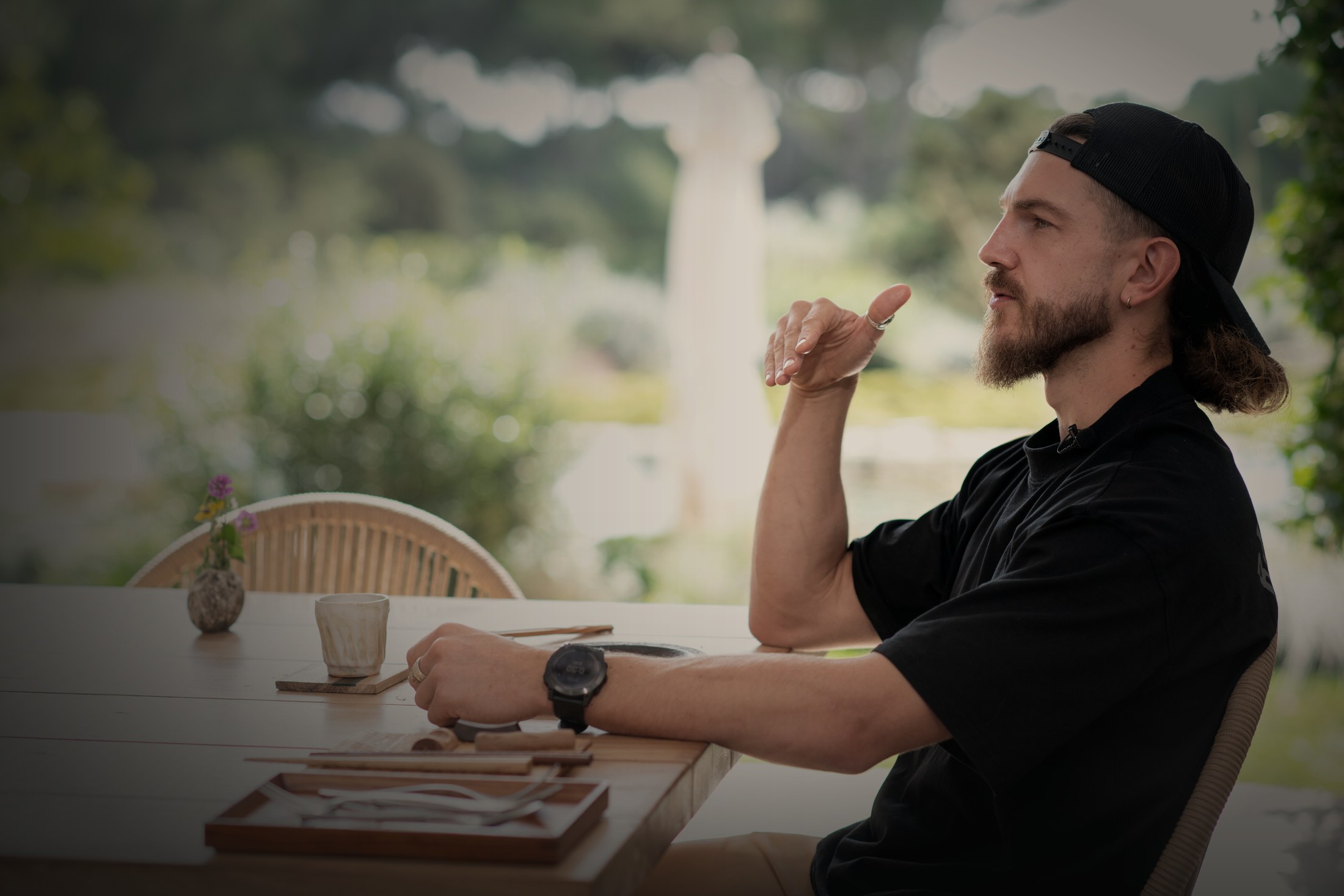 Callum Hardingham in conversation at a table in Ibiza