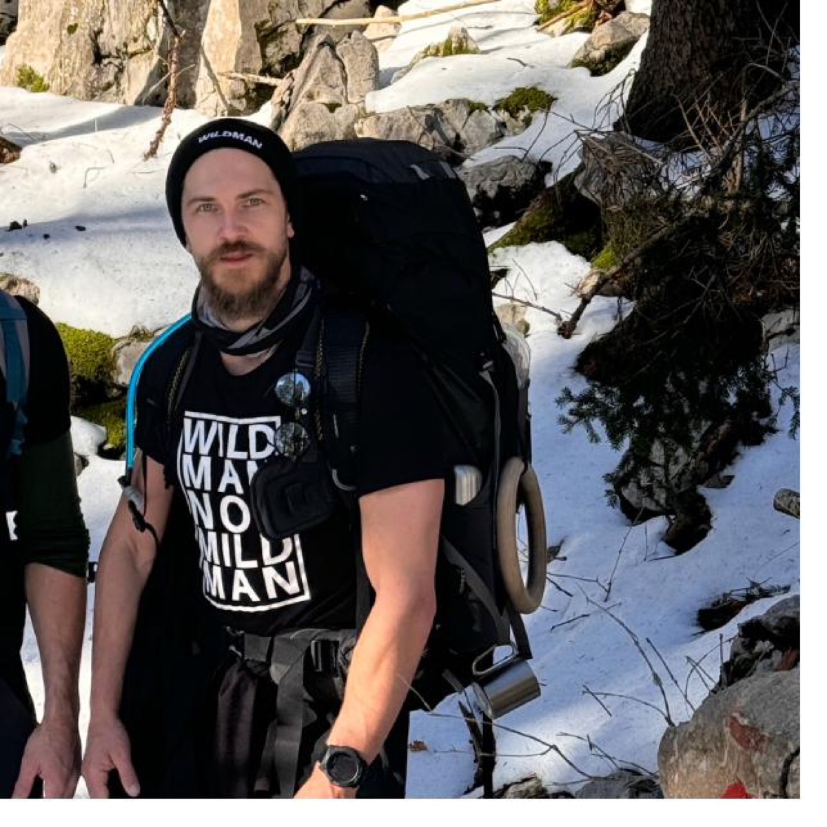 Callum on a winter mountain expedition carrying a heavy pack